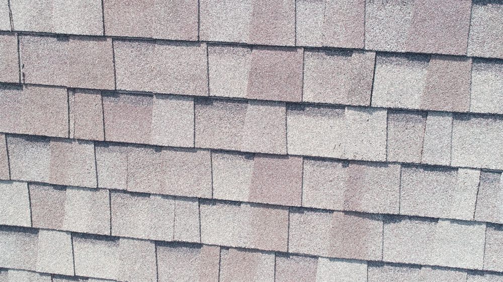 Close-up of architectural asphalt shingles installed on a DFW home
